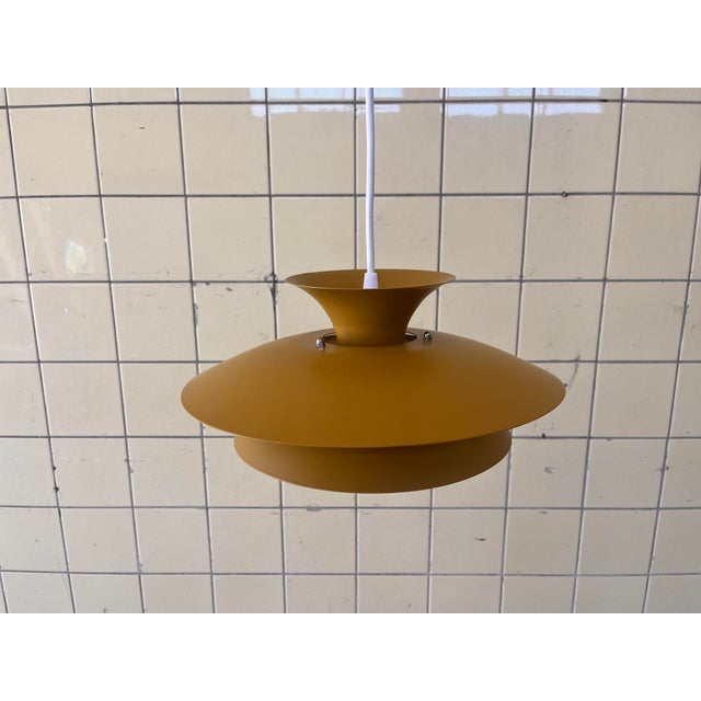 This vintage Danish pendant lamp has recently been professionally restored and refinished in a beautiful ochre yellow /...