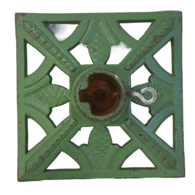 A vintage cast-iron Christmas tree stand, likely dating to the 1920s-1940s. It secures the base of a holiday tree. The...