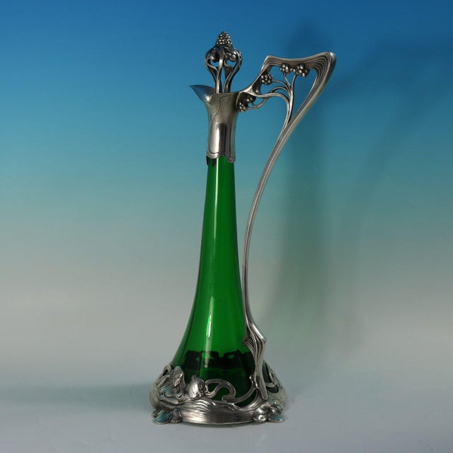Art Nouveau WMF green glass silver plated claret jug of stylised form, the mount depicting bathing maidens. The handle and...