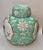 Chinese Famille Rose porcelain ginger jar with a bird and floral design. It features a traditional ginger jar silhouette...