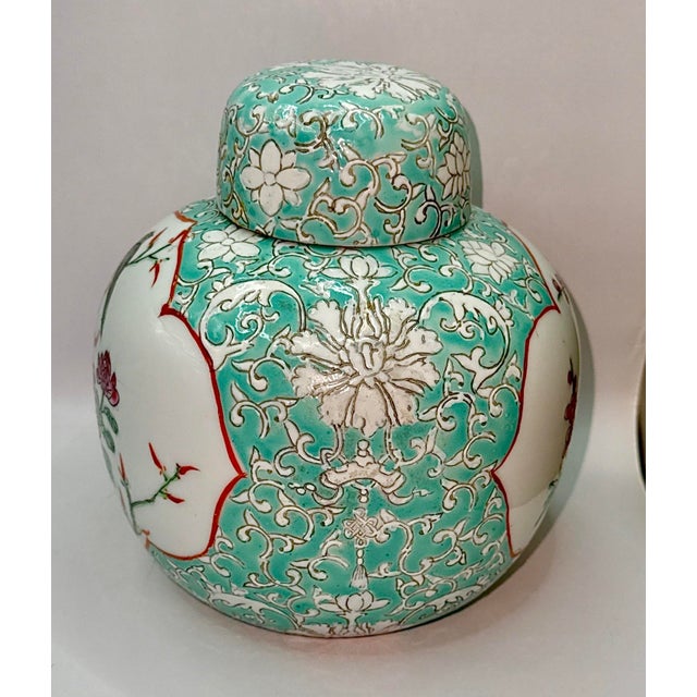 Chinese Famille Rose porcelain ginger jar with a bird and floral design. It features a traditional ginger jar silhouette...