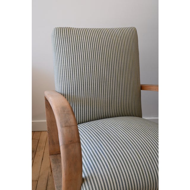 A spectacular pair of Art Deco armchairs. Substantial oak arms scrubbed to reveal a soft, tonal patina. Tall seat backs...