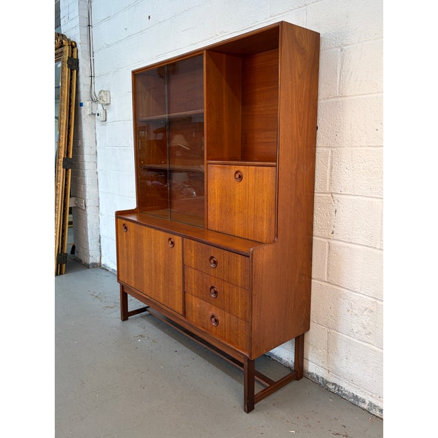 Showcase your items with timeless sophistication with this teak display cabinet by Turnidge of London, . A refined example...