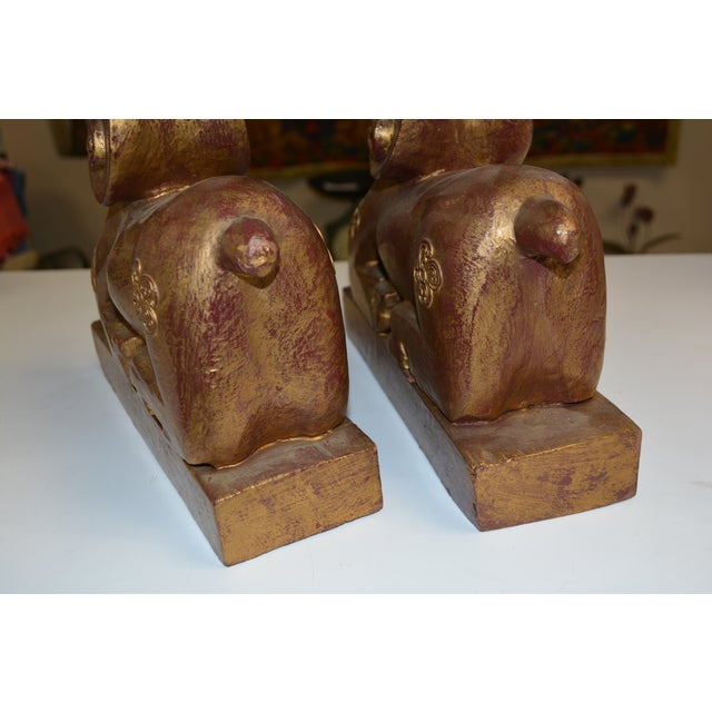 This is a great looking pair of carved wooden rams. No marks/labels. A gold wash over burgundy.