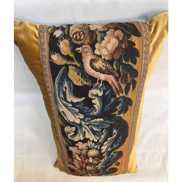 This decorative pillow is upholstered with an authentic 18th-century tapestry, showcasing a beautifully detailed bird...