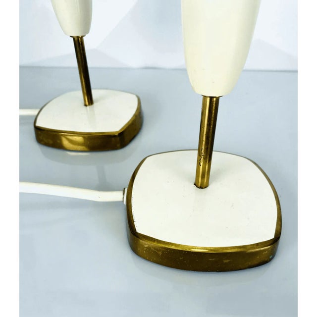 This rare bedside lamp set in a minimalist candleholder style dates back to the 1950s and impresses with its timelessly...