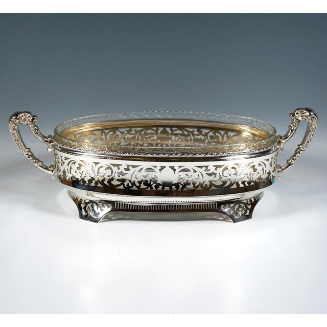 Elegant silver jardinière with an elliptical ground plan, the vertical wall slightly flared at the bottom and decorated...