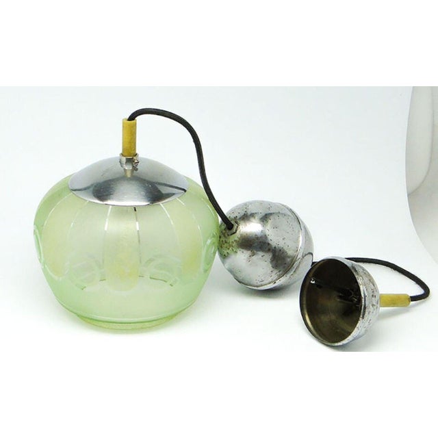The pendant lamp was produced in the 50s. The construction is brass, glass lampshade. It is preserved in very good...