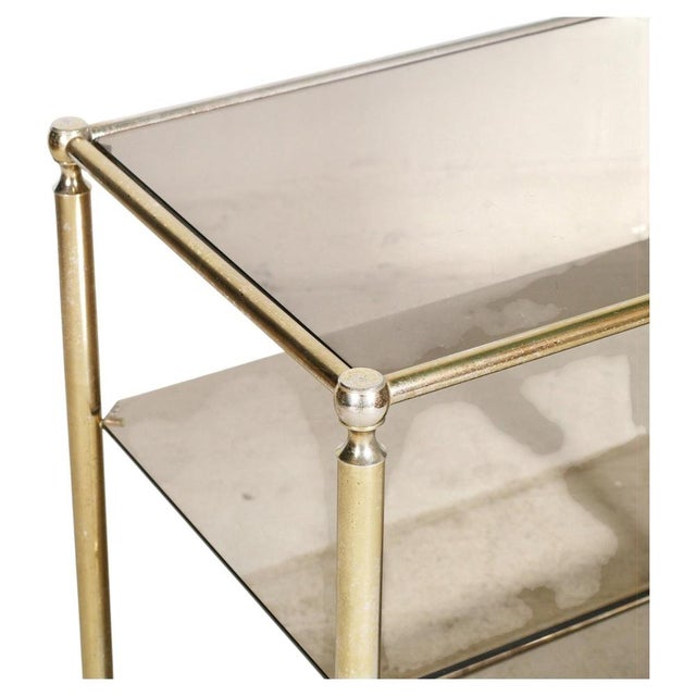 Italian Brass and Smoked Glass 3-Tier Bar Cart, 1970s, in Very Good conditions. Designed 1970 to 1979 This piece is...
