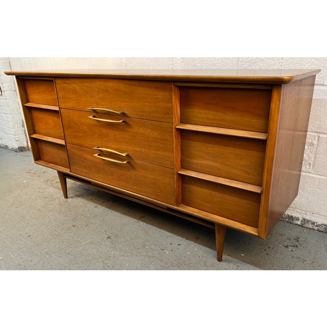 An iconic piece of American mid-century modern design, this Kent Coffey "Eloquence" 9-Drawer Lowboy Dresser offers the...
