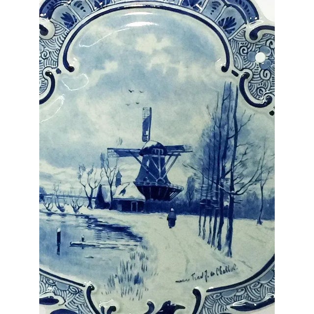 Small dutch delft porceleyne fles applique after a painting by f.j. Du chattel, 1898 a shell shaped porcelain applique...