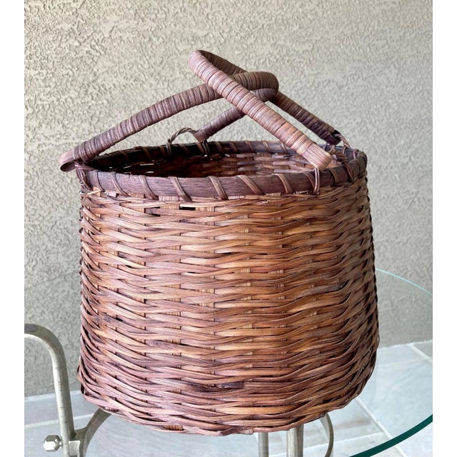 Excellent Pre-Owned Condition. This delightful rattan beauty, handwoven in a round market basket shape, is nicely-sized...