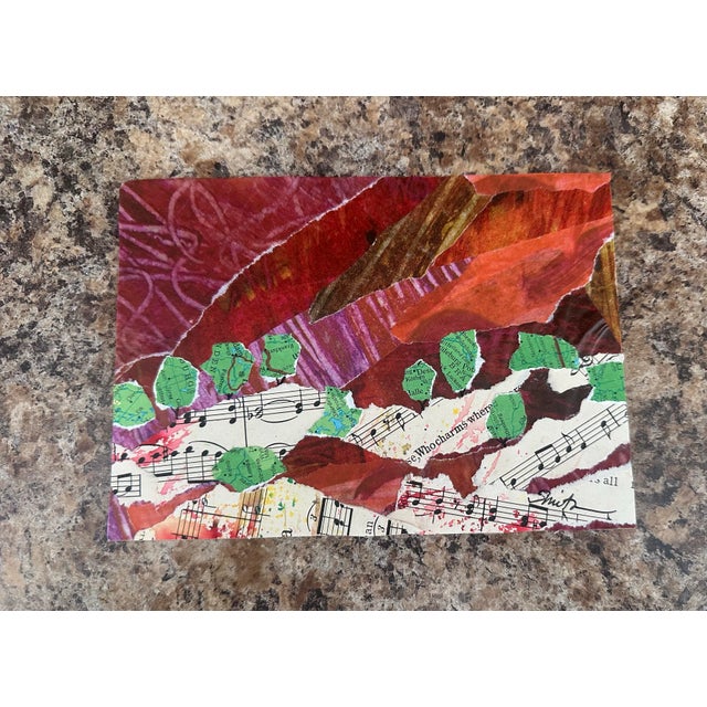 A vibrant mixed-media collage where sound, place, and nature intertwine. Warm reds, rusts, and oranges form a rich...