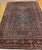 "An early 20th century room-size hand-knotted Persian Bibikabad rug featuring the classic Herati geometric pattern set...