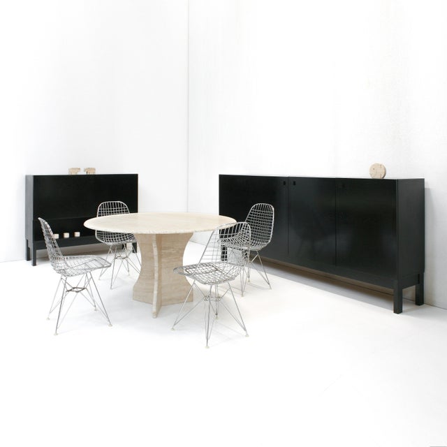 A large travertine dining table with rounded edges and sculptural base in great condition.