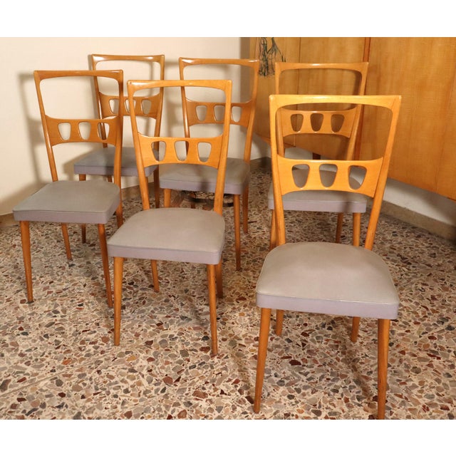 Set of 6 chairs with a maple frame and light gray leather upholstery. The frame is in the typical style of the late period...