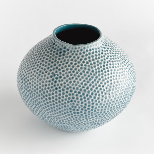 With a simple shape, reactive glaze and highly textured organic dot pattern, this decorative vase is a true work of art. A...