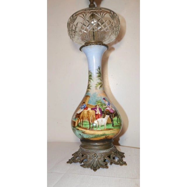 Up for sale is a high quality antique hand painted porcelain, glass, and bronze electrified oil lamp. the body of the lamp...