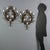 Pair of painted iron and sheet metal wall sconces. Six lights supported by curved arms, part of a floral and leafy wreath...