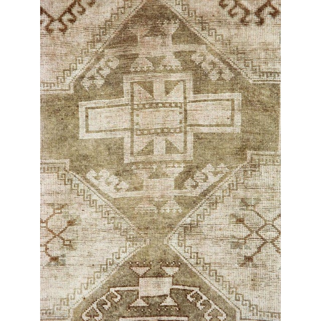 This mid-20th-century Turkish Anatolian gallery carpet presents three large, vertically aligned geometric medallions...