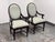 Design Plus Gallery presents a Pair of Oval-Back Dining Armchairs by Bernhardt Furniture. Each chair has a mahogany-toned...