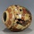 This round lidded jar is crafted in classic Japanese Satsuma style. The cream aged ground is decorated with a vibrant...
