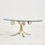 Brass coffee table from the 1970s. The table has an organic-shaped base and a hardened glass top. with some surface...