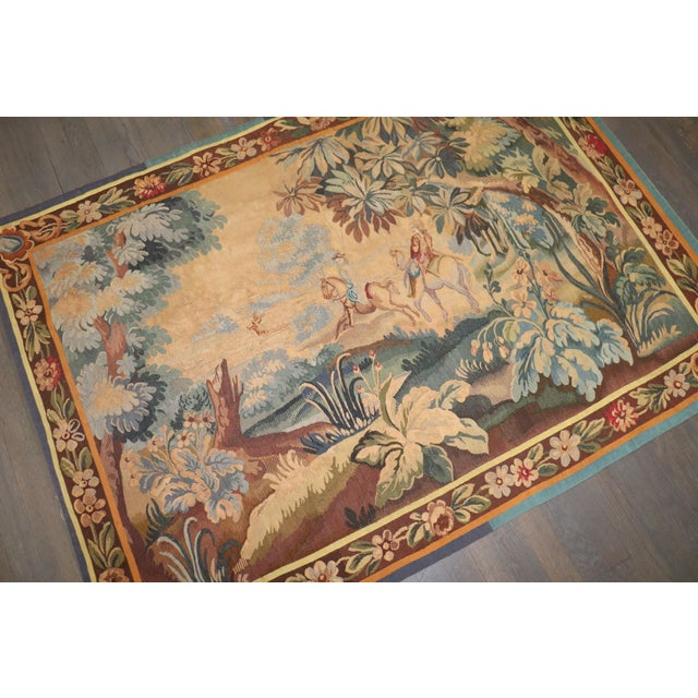 An exceptional French Aubusson-style flatweave tapestry rendering a classic 18th-century fête galante pastoral scene....
