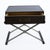 A pair of campaign-style nightstands wrapped in brass, their gleaming metal surfaces and campaign corners giving them a...