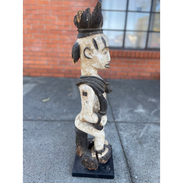 Striking and expressive, this carved Urhobo figure from southern Nigeria exemplifies the powerful sculptural language of...