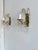 Elegant pair of French vintage wall sconces dating from the 1940s, crafted from shaped brass and decorated with clear...