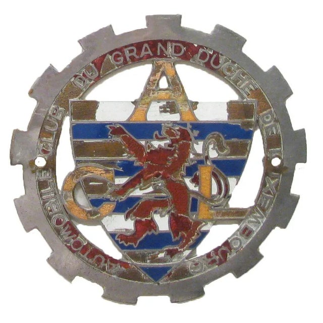 Collection of car rally and bicycle badges found at a Brussels antique market. Includes Paris and Luxembourg automobile...