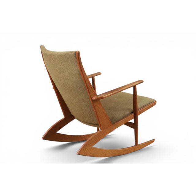 This Model 97 T/T rocking chair brings a gently curved teak frame together with soft fabric upholstery for a comfortable,...