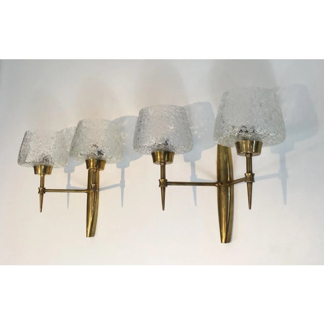 This beautiful pair of wall sconces is made of bronze and has worked glass reflectors. The quality of these wall lights is...