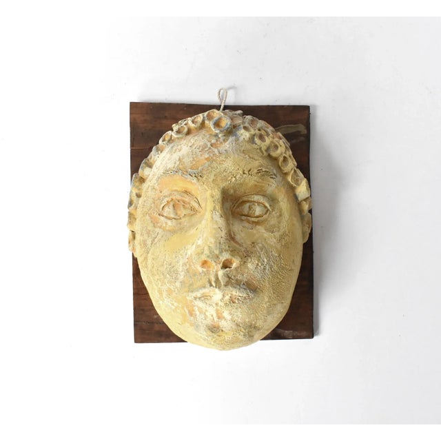 A vintage, mid-century studio or art pottery ceramic pottery sculpture of a face, with a layered and textures glaze...