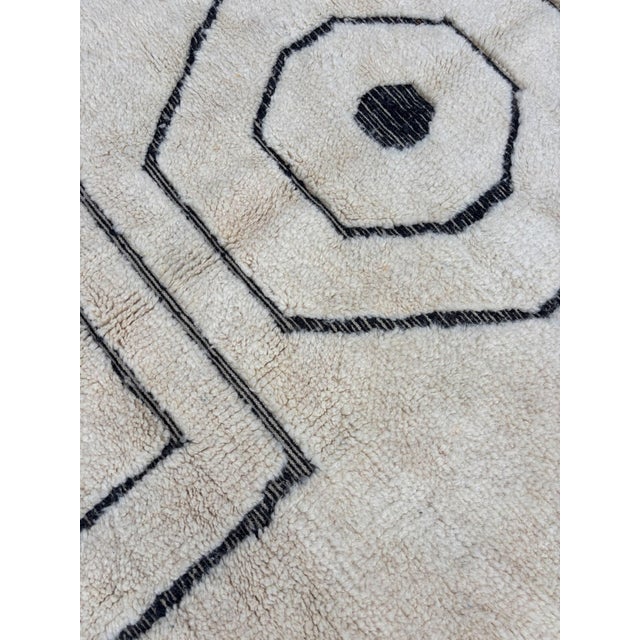 Add a touch of authentic Moroccan elegance to your home with this exquisite Beni Ourain Wool Rug. Handcrafted by skilled...
