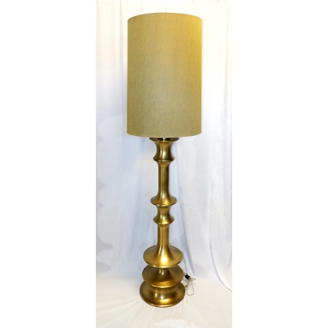 Unique out of production Waldo floor lamps. Large-scale metallic spindle floor lamp in an antique brass finish has a...