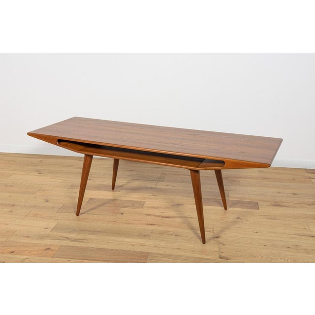This Model 100 coffee table was made in the 1950s by Omann Jun Møbelfabrik. The furniture has a unique form. It was...