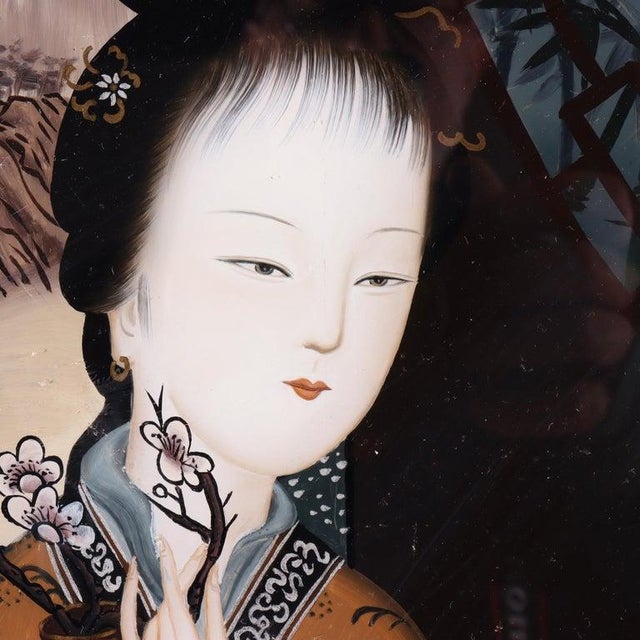 Presenting an antique Chinese wall panel with a portrait of a woman reverse painted on glass and seated in an ebonized...