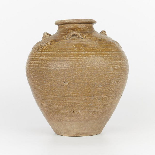 This wonderfully large Chinese ceramic vase or storage jar dates from the Ming dynasty(1368-1644) With a beige glaze and...
