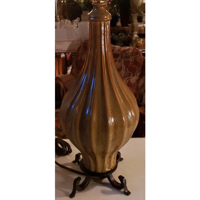 Beautiful green lamp with unique design and black wood base. Used regular bulb, regular 2 prong plug. We have 2 lamps...