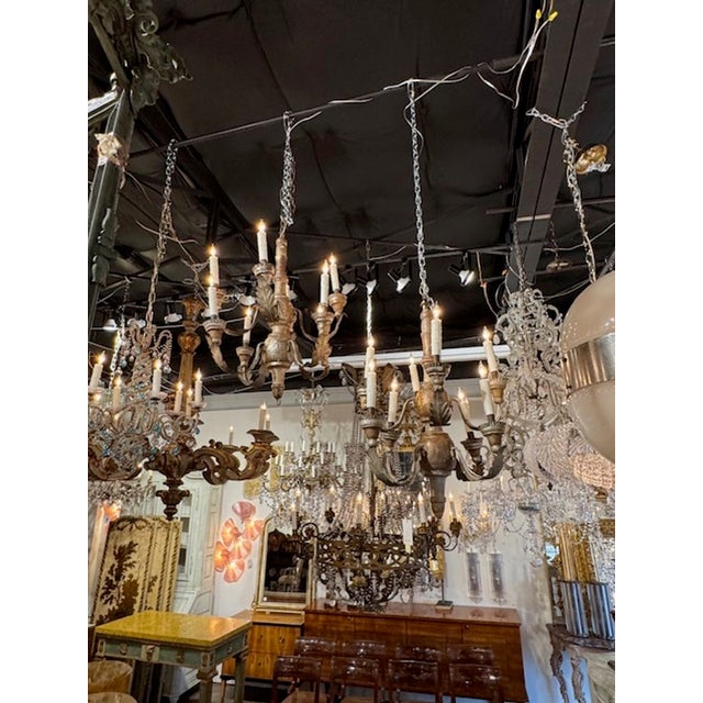 Pair of 19th century Italian silver gilt wood and iron chandeliers from Tuscany. Circa 1850. These chandeliers have been...
