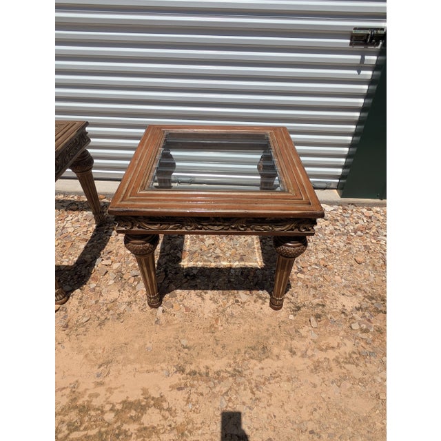 These Thomasville tables are made of solid wood with ornate carvings. These tables both feature a glass top. Their design...