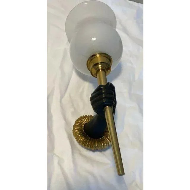 c1920's French Art Deco Gilt & Patinated Bronze Wall Sconce. Hand holding torch form with opaline shade. Attrib. Andre Arbus.
