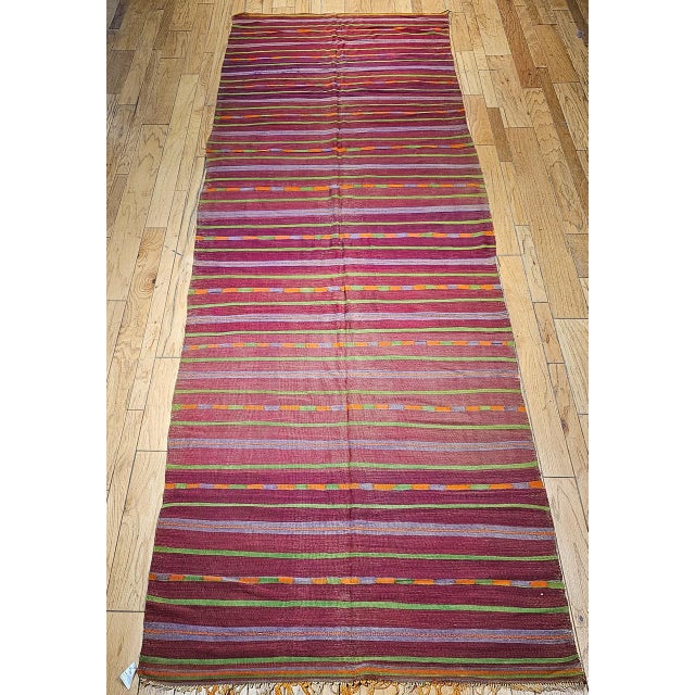 A beautiful vintage Moroccan Berber rug from the third quarter of the 20th century in a softly luminous stripe pattern —...