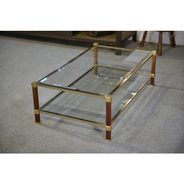 A gilded brass frame accented with slender stretchers, varnished wood-clad uprights, and fluted rings typical of the...