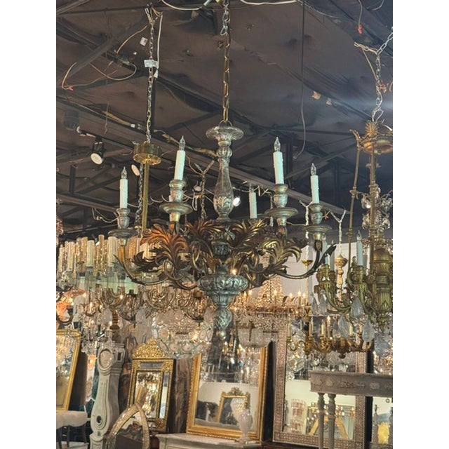 This Vintage Italian Silver and Gold Leaf Chandelier exudes elegance and sophistication with its intricate design...