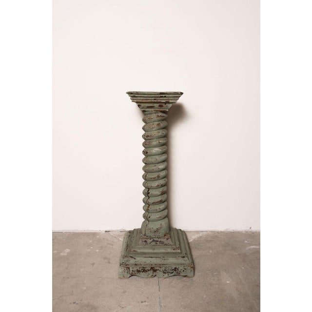 A striking antique French display pedestal featuring a monumental barley twist column, stepped base, and beautifully...