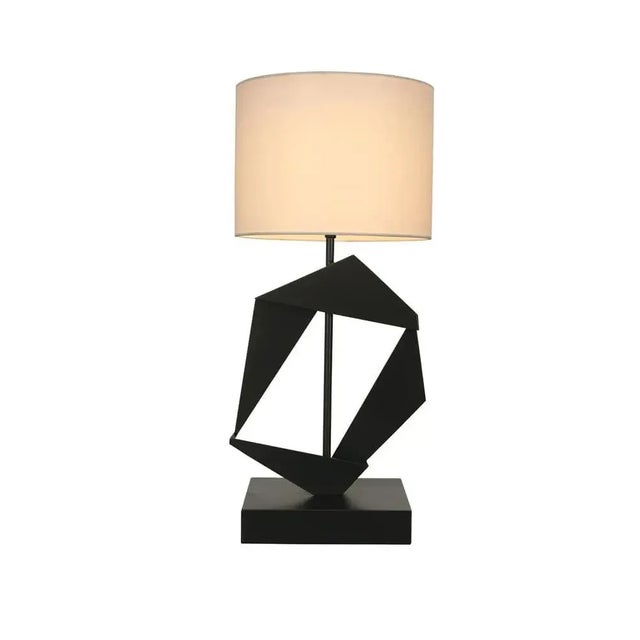 The Timothy Table Lamp with Shade is a stunning handcrafted piece designed to captivate with its origami-inspired design...