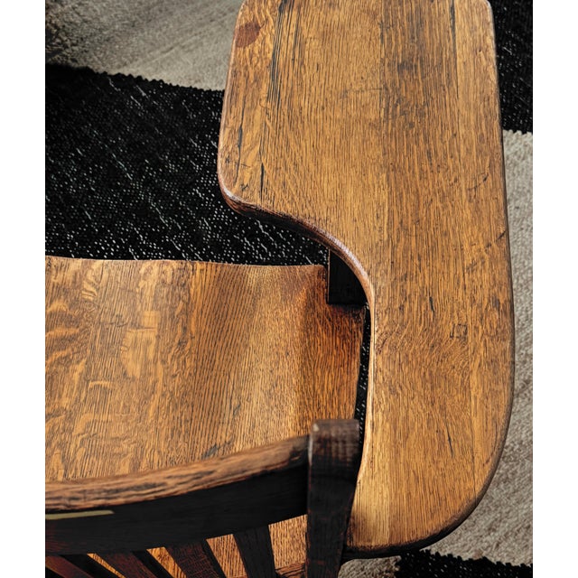 Mid-century oak school desk chair with integrated writing arm and original lower book stretcher. Beautiful quarter-sawn...